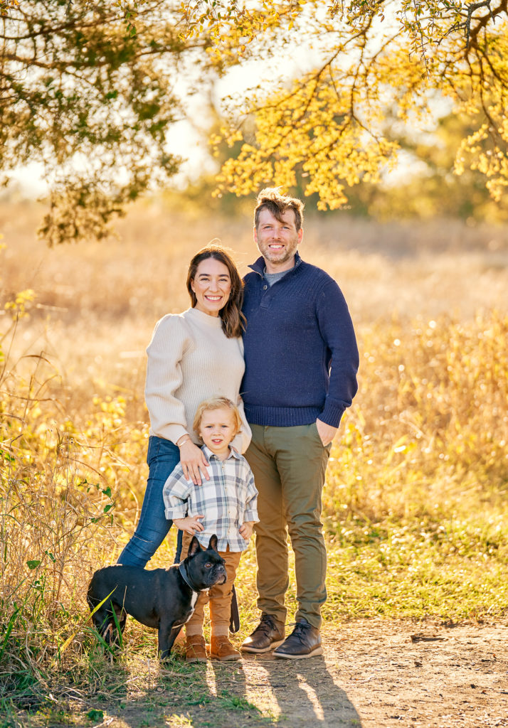 Family of four posing together at Erwin Park in McKinney, tx